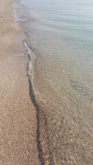 Wave, sea, footprints on the beach