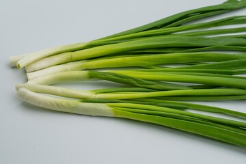 Fototapeta premium Fresh green onions on a white background. Healthy food.