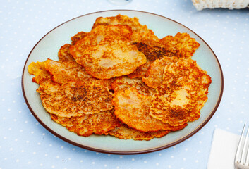 Belarusian potato pancakes draniki with sour cream at plate, nobody