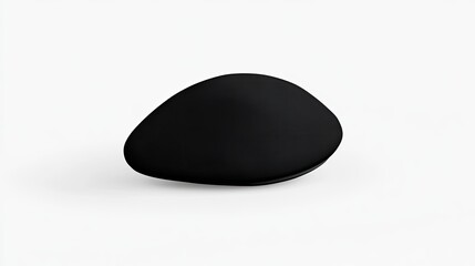 A smooth, abstract black stone-like object resting on a minimalist white surface