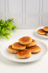 Kue kamir. Kamir cake on a white plate. Also called khamir. Perfect for recipe, article, catalogue, or any commercial purposes.