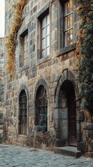 Fototapeta premium Charming stone building with arched windows, surrounded by cobblestone paths and greenery