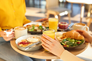 Women having tasty breakfast in cafe, closeup