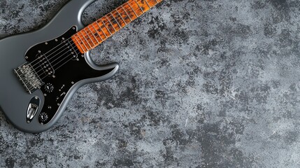 Gray electric guitar on textured surface