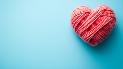 Pink Heart-Shaped Yarn on Blue Background