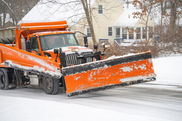 snowplow driving on residential street