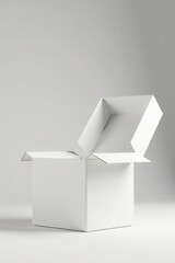 A partially opened blank white cardboard box sits on a plain surface against a neutral background