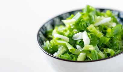 Obraz premium Chopped green onions in a bowl