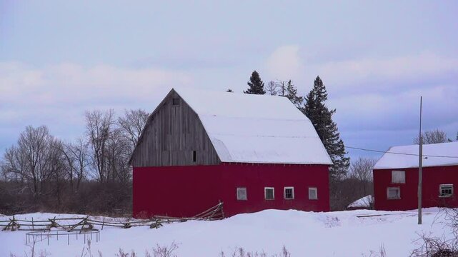 A red barn in a snowy field
