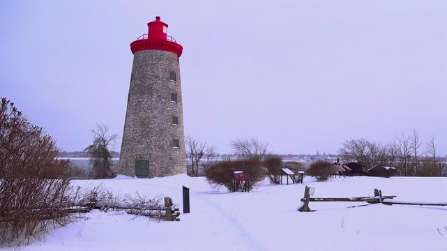 A tall, stone made building in the winter
