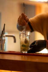 bartender photo - preparing a mojito in different glasses