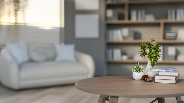 A close-up of a round wooden coffee table set in a contemporary living room.