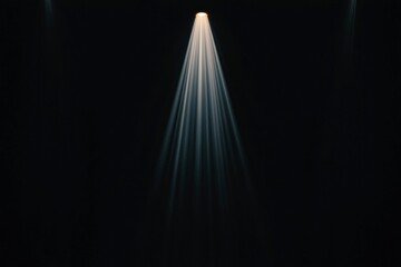 Dramatic spotlight illuminating a dark stage, creating a moody atmosphere for performances