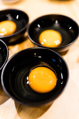 Raw egg served on black bowl as sauce of sukiyaki, hygienic egg safe to eat raw