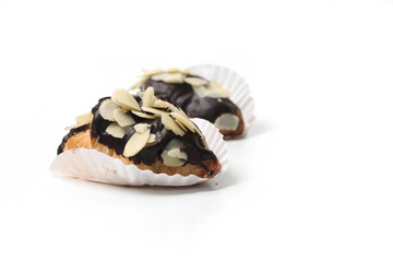 croissants with chocolate and sliced almonds topping, isolated on white background, perfect for recipes, articles, catalogues, commercials, or any cooking contents.