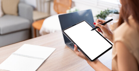 Woman using digital tablet at home, mockup blank white screen device