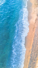 Aerial view of beautiful sandy beach and sea wave in summer time