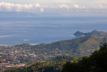 A beautiful view of Dili, the capital of East Timor, seen from a hill on the outskirts of the city. In the distance, the Cristo Rei statue, the icon of Dili, is visible.