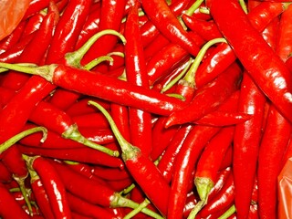 Top View of Fresh Spicy Red Chilli Peppers (Cabe Merah Besar) at Traditional Market. Detailed Texture, Pattern, and Background.