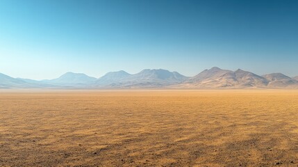 Fototapeta premium Expansive desert landscape with distant mountains under a clear blue sky, evoking tranquility