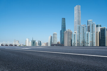 Modern Urban Skyline with Clear Blue Sky and Empty Road
