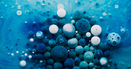 Oil blob. Paint mix. Colorful gel drops floating on marble water surface. Fantasy blue white abstract particles liquid background.