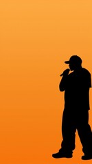 Silhouette of a rapper performing on stage, orange background, music concert