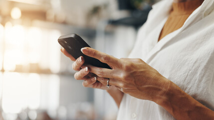 Person, hands and phone in small business for contact., social media update and ecommerce in boutique. Entrepreneur, store owner and typing on mobile for networking, online shopping and