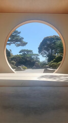 Fototapeta premium Serene Garden View Through Circular Window Illustration