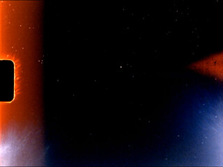 Light leaks and film grain creating abstract background texture with orange and blue tones