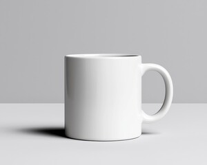 A clean and minimalistic white coffee mug on a gray surface, perfect for branding and lifestyle photography.