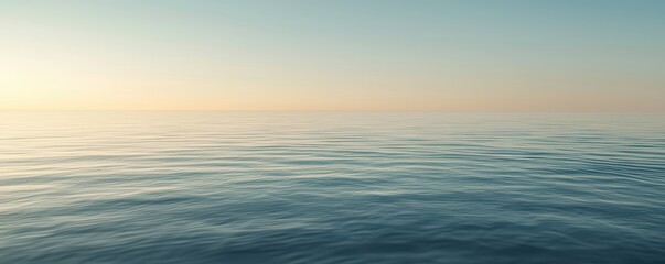 Fototapeta premium A tranquil seascape showing calm waters reflecting soft colors of dawn or dusk, evoking serenity and peace.