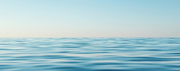 Tranquil water stretches to the horizon under a clear blue sky, creating a serene and peaceful atmosphere.