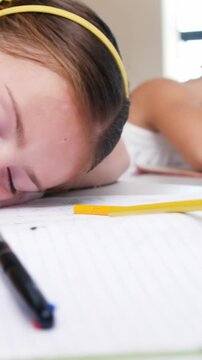 School kids sleeping on desk in classroom