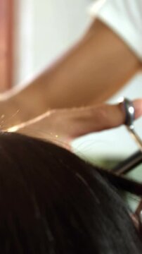 Woman getting his hair trimmed with scissor