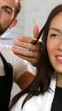Woman getting his hair trimmed with scissor