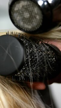 Woman getting his hair dried with hair dryer