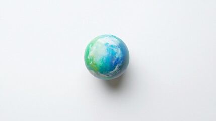 A painted globe on a white surface, depicting a watery world with clouds