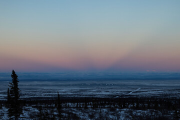 Colorful sun rays in Alaskan sky