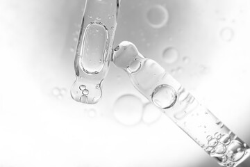 samples serum tests glass pipettes with drops of serum on a black and white background