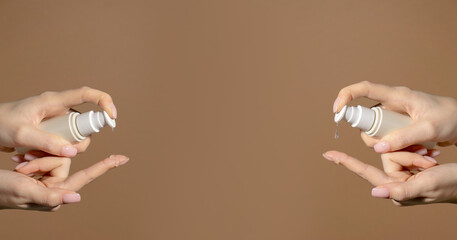 Banner. Females hands holds bottles with dispenser with cosmetic serum. Natural cosmetic product for skin purity, hydration. Unmarked bottle with product for face skin care