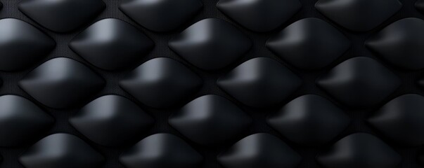 Textured black surface with smooth, curved shapes.