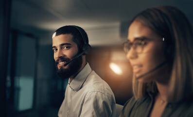 Night, office and portrait of man in callcenter with friendly smile, crm and phone call at help desk. Virtual assistant, consultant or customer service agent with headset, online support or advice