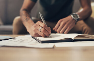 Bills, sofa and hands of man writing finance notes with invoice, home budget and income tax report....