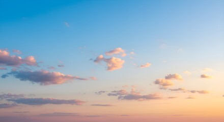 Blue sky transitioning into soft pastel hues, with sparse clouds tinged with golden and pink shades as the sun begins to set