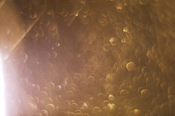 Abstract Golden Bokeh Background with Circular Light Patterns and Soft Glow