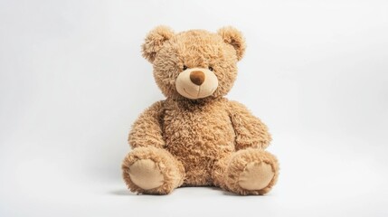 Obraz premium A soft, fluffy teddy bear with a warm expression rests on a light surface, inviting cuddles and companionship. Its inviting presence enhances any cozy atmosphere