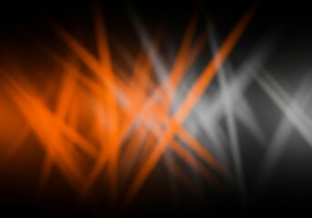 The dynamic and abstract nature of this image is highlighted by the blurred lines of orange and white light intersecting and overlapping against a dark background