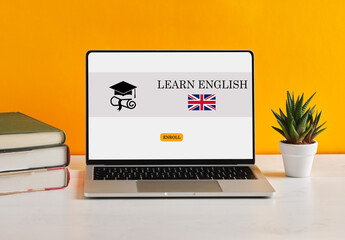 Woman learning English online using laptop with United Kingdom flag on screen