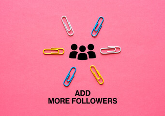 Colorful paper clips pointing to followers icon and add more followers writing on pink background